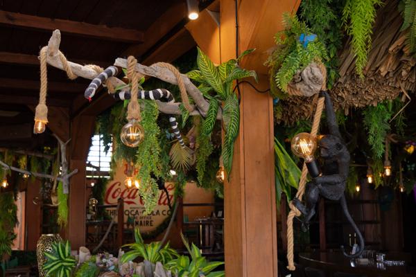 Decorative faux reptiles and exotic animals are placed throughout the interior to enhance the adventurous jungle atmosphere.